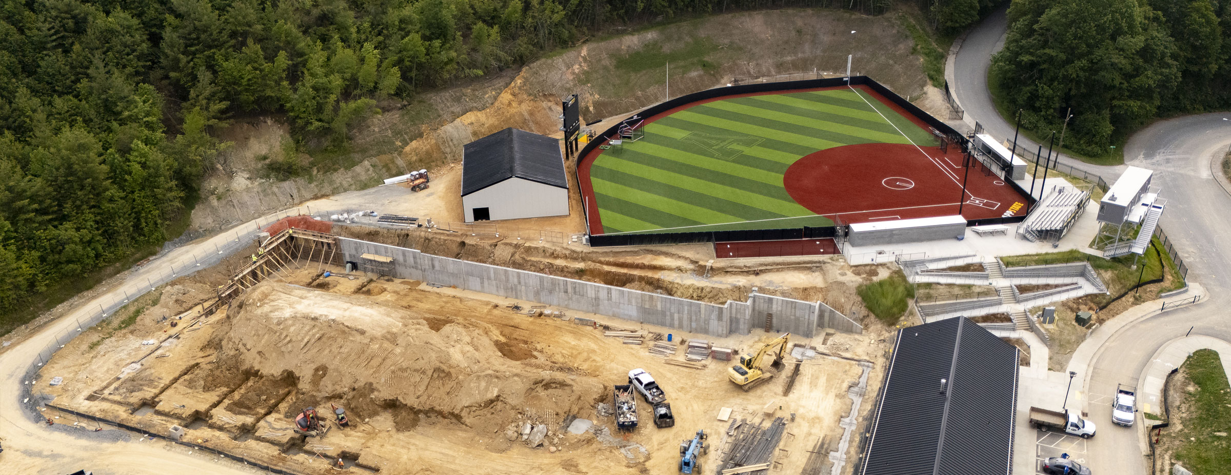 Aerial view of workers building retaining wall at Appalachian 105 tennis site, June 11, 2025.
