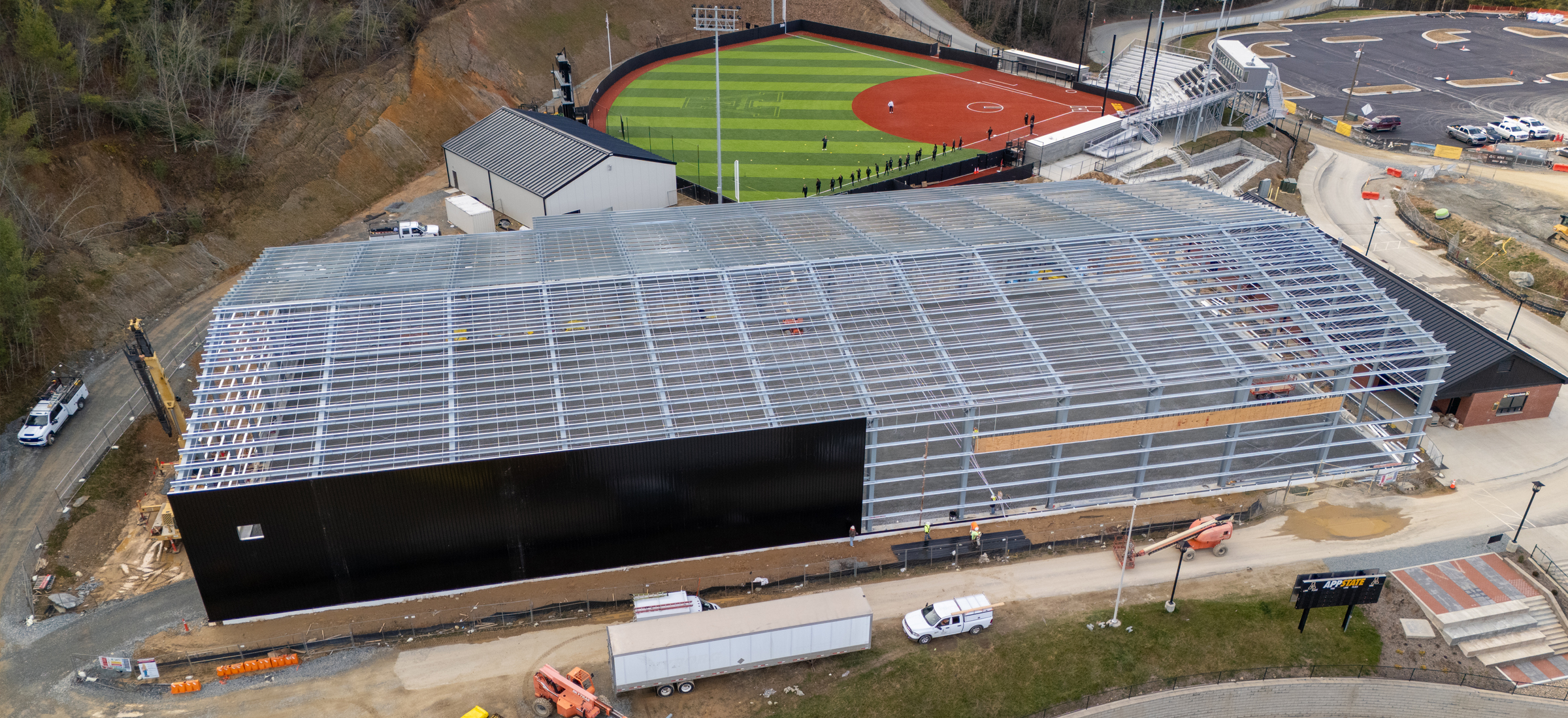 Workers have begun applying metal wall panels to the structural steel frame of App State's indoor tennis courts facility.