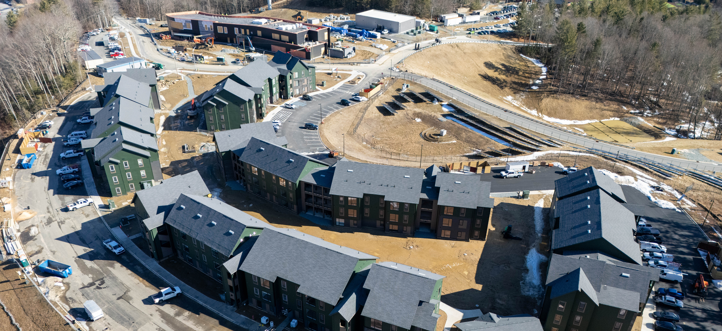 Aerial photo of Phase 1 Innovation District work with housing in foreground and STEM facility in background.
