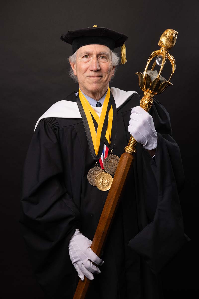 Joseph Bathanti holding the university mace.